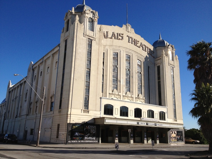 Colour photograph of the façade of a multi-storey Art Deco theatre with the sign, 'Palais Theatre'.
