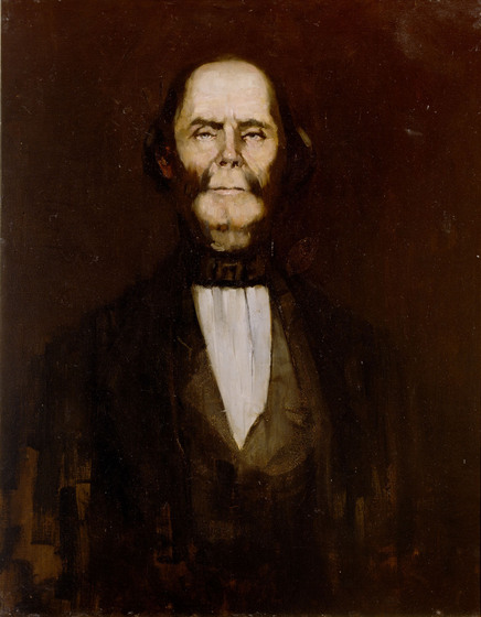 Portrait of an older man dressed in Victorian era clothes. He is rather gaunt in the face and is balding on the top of his head.