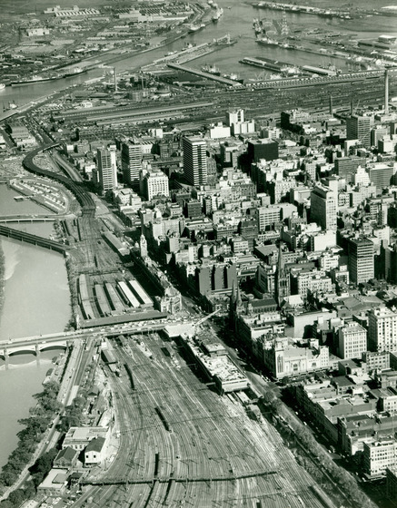 Aerial view of the city of Melbourne. The scene is dominated by the railway tracks that wind past and around the city buildings.