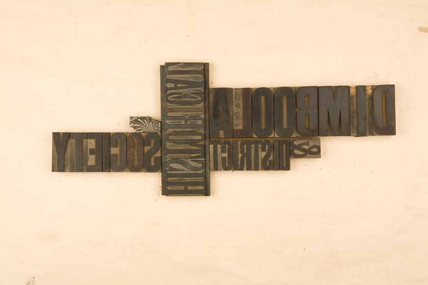Four different examples of wooden loose type stamps. They are all squeezed together both vertically and horizontally.