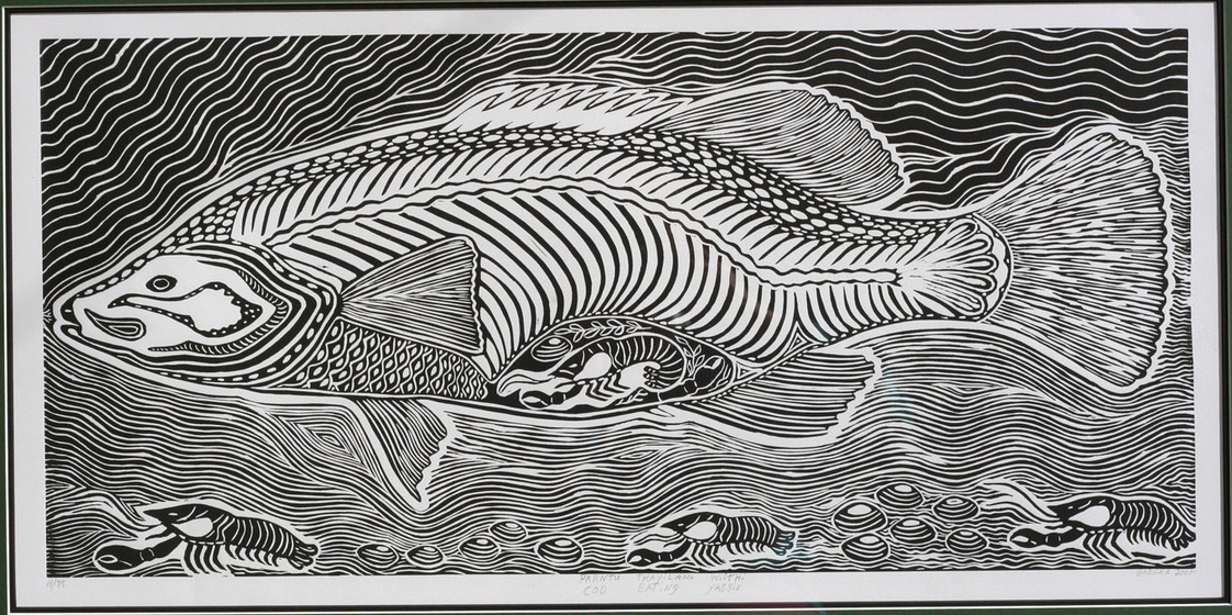 A black and white linoprint of a cod shaped fish swimming through water. In the cods belly are yabbies. On the bottom of the river are yabbies and shells.