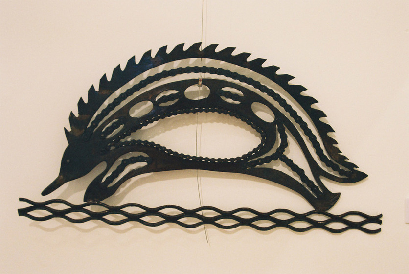 Metal sculpture of an echidna. It is 2D and is from the side on.
