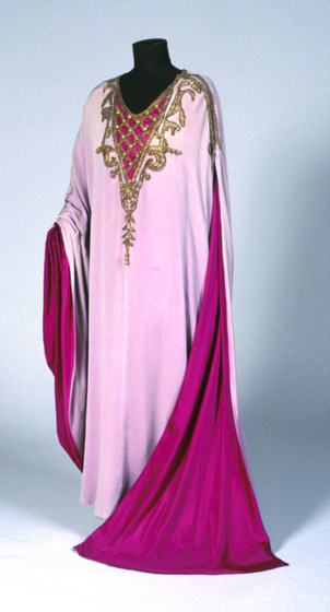 Two toned pink gown on a black mannequin. The chest region of the gown features gold embroidered detailing.
