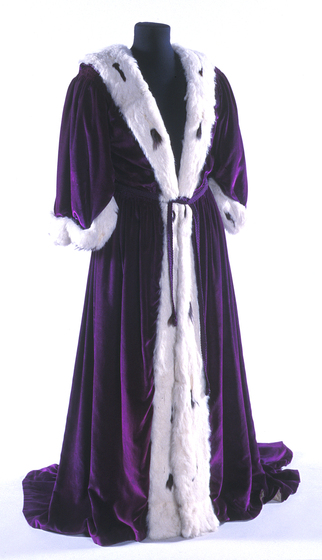 Purple velvet floor length dressing gown with white fluffy trim.