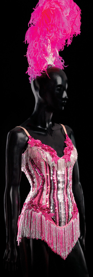 Mannequin wearing pink, silver and white sequin, bugle bead and fringe ‘showgirl’ corset, and a pink ostrich feather and diamante head dress.
