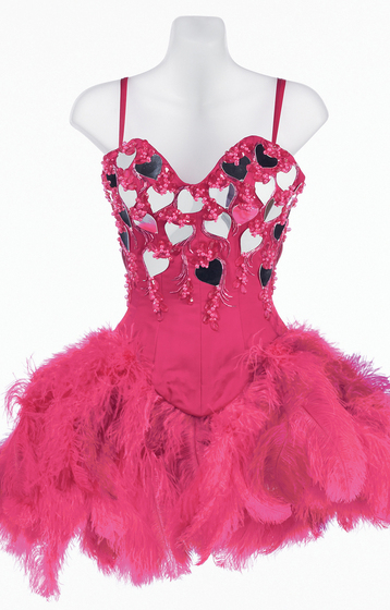Mannequin wearing pink silk corset dress with feather skirt and mirror heart trim over the bodice