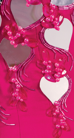 Detailed view of the mirror hearts, attached to a pink bodice and surrounded by pink beads