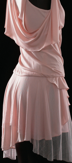 Detailed view of mannequin wearing a pale pink silk jersey dress with silk net detail.