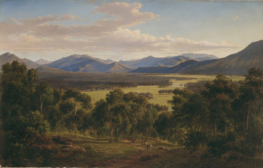 In the foreground a man on a horse musters a handful of sheep through an open valley surrounded by eucalypt trees. In the background an open green plain stretches into green rolling hills and mountain peaks.