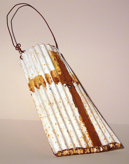 Sculpture of a bag using a sheet of tin for the body and wire for the handle.
