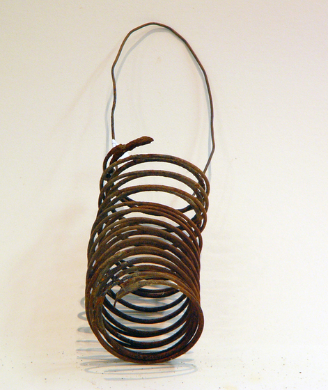 Sculpture of a bag using a metal coil for the body and wire for the handle.