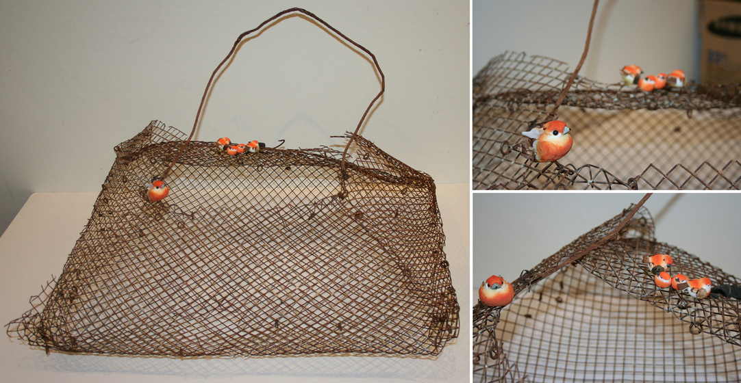 Three separate images showing different angles of a basket made from tightly woven metal mesh. On the rim of the basket are sculptures of five little orange finches.