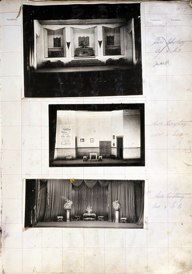 Three black and white photographs of different set designs, stuck to a scrapbook page. There are some hand written notes in the margin.
