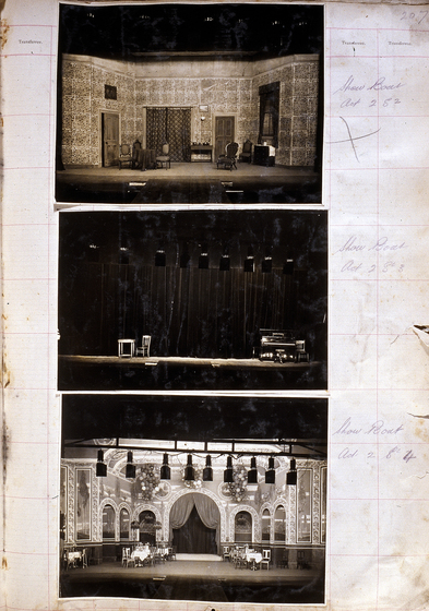 Three sepia photographs of different set designs, stuck to a scrapbook page. There are some hand written notes in the margin.