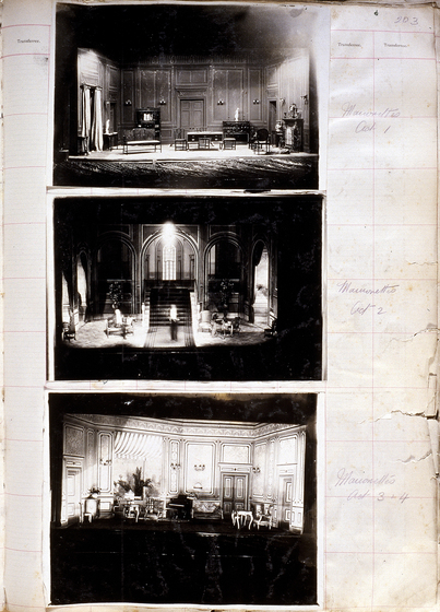 Three black and white photographs of different set designs, stuck to a scrapbook page. There are some hand written notes in the margin.
