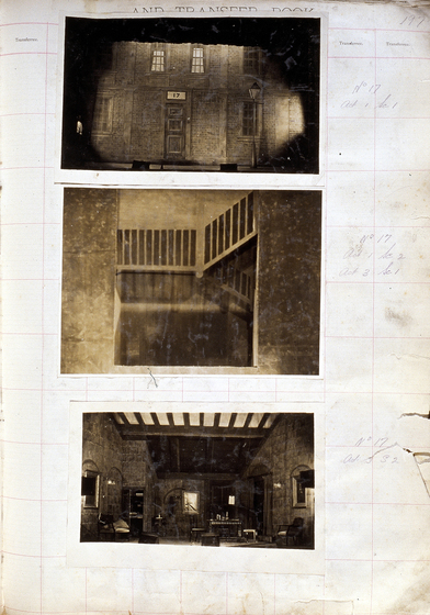 Three sepia photographs of different set designs, stuck to a scrapbook page. There are some hand written notes in the margin.
