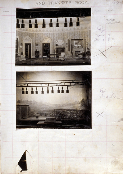 Two sepia photographs of different set designs, stuck to a scrapbook page. There are some hand written notes in the margin.
