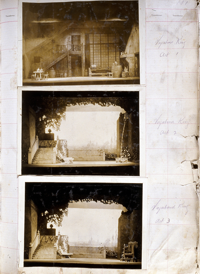 Three sepia photographs of different set designs, stuck to a scrapbook page. There are some hand written notes in the margin.