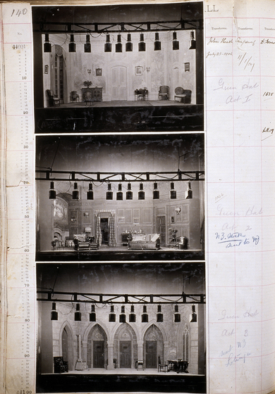 Three black and white photographs of different set designs, stuck to a scrapbook page. There are some hand written notes in the margin.