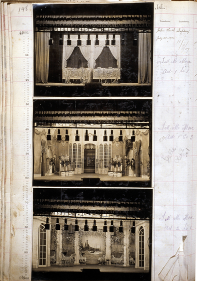 Three sepia photographs of different set designs, stuck to a scrapbook page. There are some hand written notes in the margin.