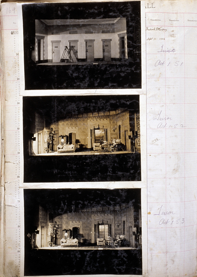 Three sepia photographs of different set designs, stuck to a scrapbook page. There are some hand written notes in the margin.