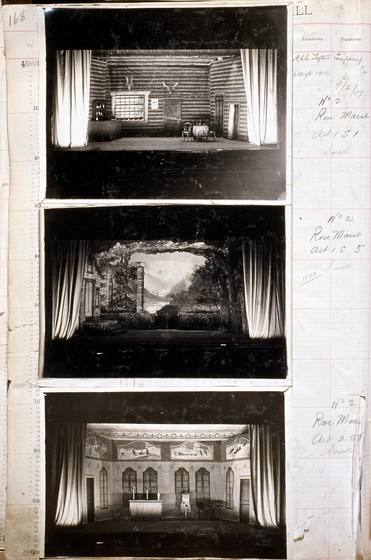 Three black and white photographs of different set designs, stuck to a scrapbook page. There are some hand written notes in the margin.