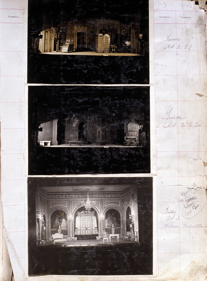 Three sepia photographs of different set designs, stuck to a scrapbook page. There are some hand written notes in the margin.