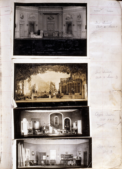 Three sepia photographs of different set designs, stuck to a scrapbook page. There are some hand written notes in the margin.