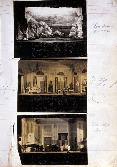 Three sepia photographs of different set designs, stuck to a scrapbook page. There are some hand written notes in the margin.