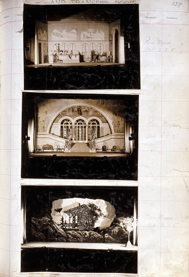 Three sepia photographs of different set designs, stuck to a scrapbook page. There are some hand written notes in the margin.