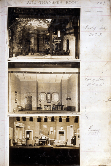 Three sepia photographs of different set designs, stuck to a scrapbook page. There are some hand written notes in the margin.