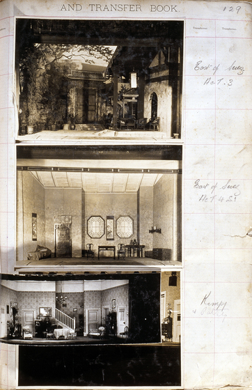 Three sepia photographs of different set designs, stuck to a scrapbook page. There are some hand written notes in the margin.