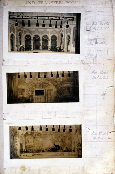 Three sepia photographs of different set designs, stuck to a scrapbook page. There are some hand written notes in the margin.