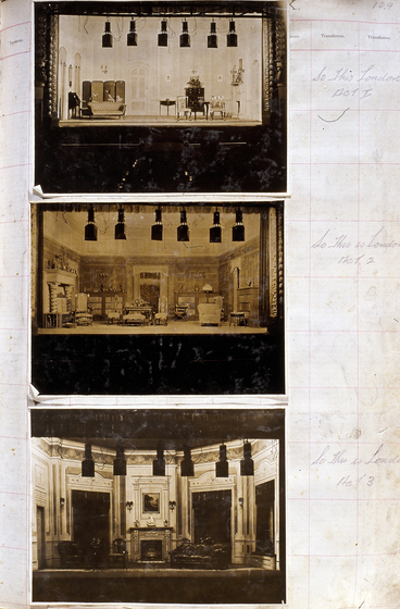 Three sepia photographs of different set designs, stuck to a scrapbook page. There are some hand written notes in the margin.