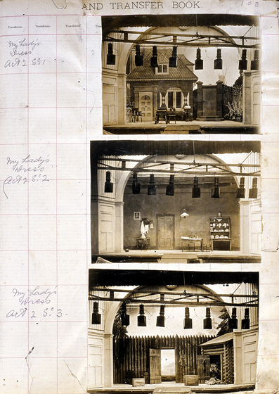 Three sepia photographs of different set designs, stuck to a scrapbook page. There are some hand written notes in the margin.