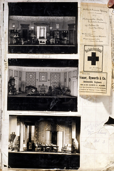 Three black and white photographs of different set designs, stuck to a scrapbook page. There are some hand written notes in the margin and a newspaper article clipping.