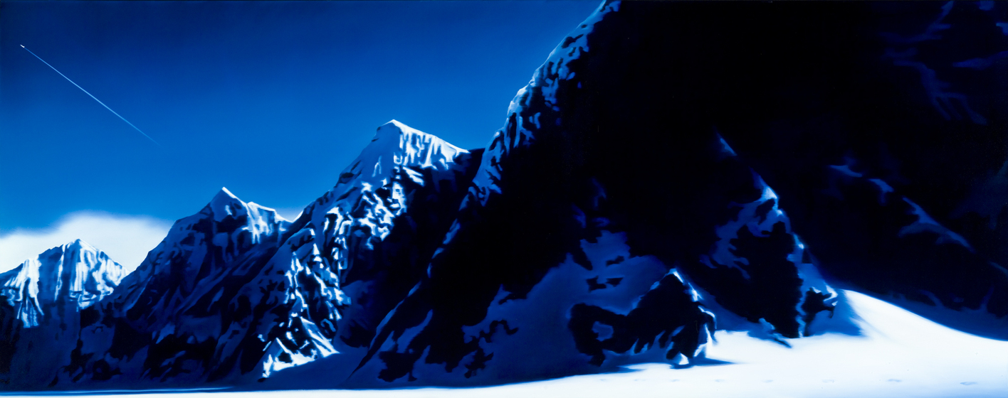 Mountain landscape with snow capped peaks and rocky outcrops.