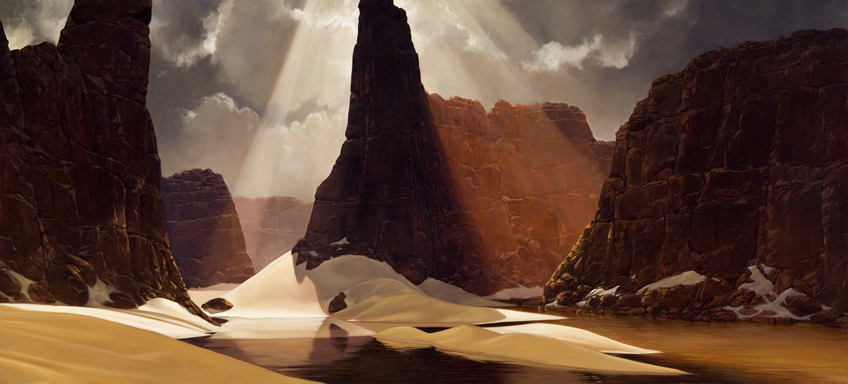 sand dunes roll through a valley, surrounded on all sides by sheer brown rocky cliffs rising out of the dunes. Sun beams pour from the sky, reflecting over the rocks and sand.