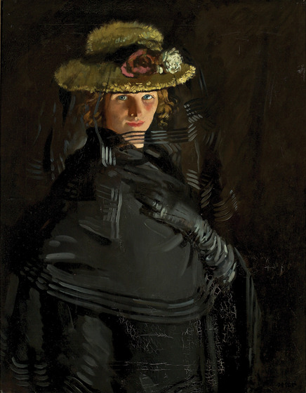 Portrait of a woman dressed in a black dress, gloves and shawl. She is wearing a straw hat with flowers on the rim.
