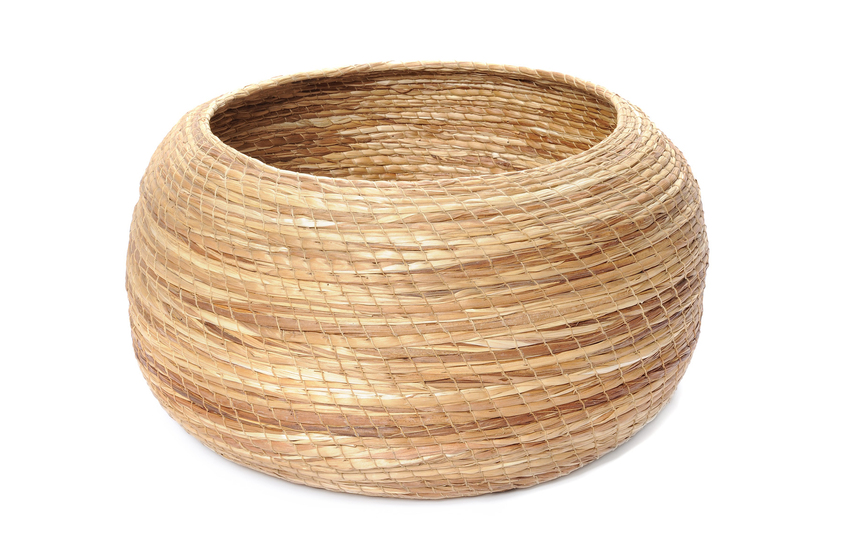 Circular woven basket made from organic material.