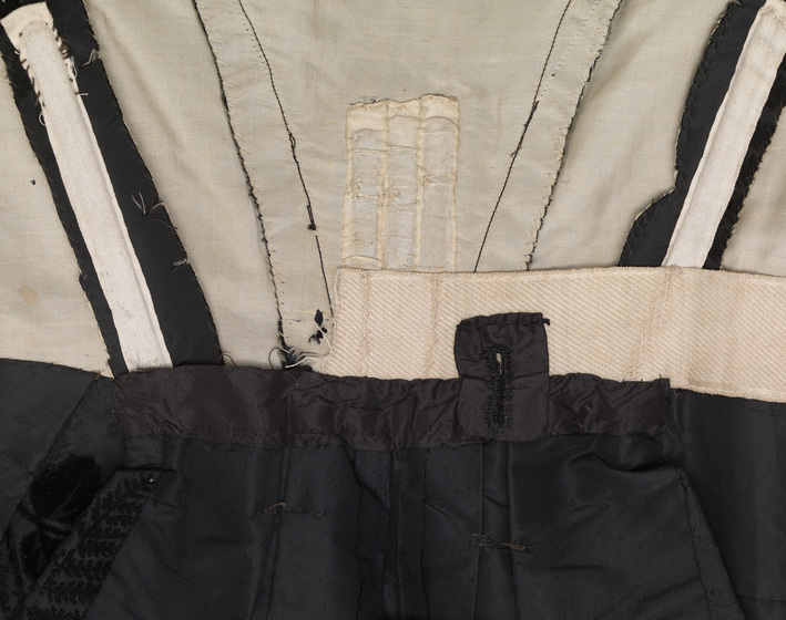 Detailed view of the inside of the bodice, including stitching of seams and waistlines.