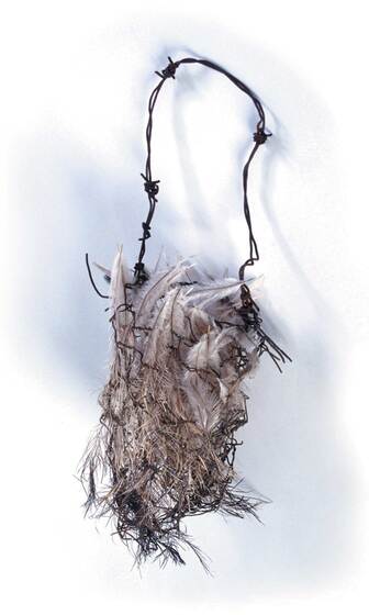 A small wire mesh bag covered in emu feather, with a handle made of barbed wire.