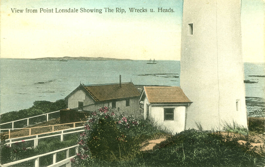 Postcard of a small white cottage next to the base of a lighthouse. White fences stretch away from the cottage along the cliffs edge, and greenery is scattered around the scene. In the distance is the ocean.