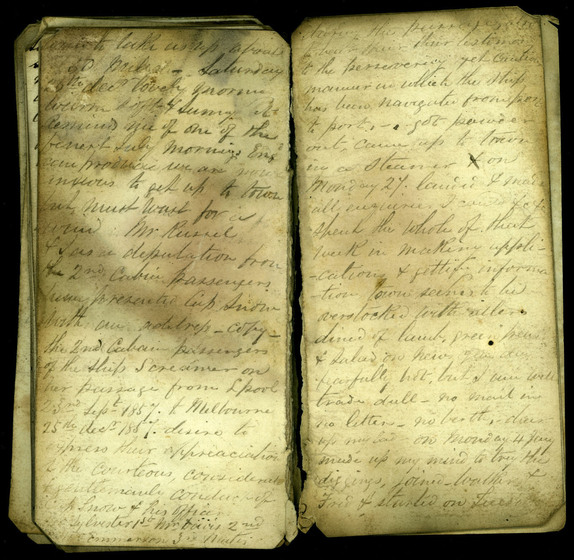 Cursive hand written diary pages on yellowing paper, slightly smudged with black ink stains