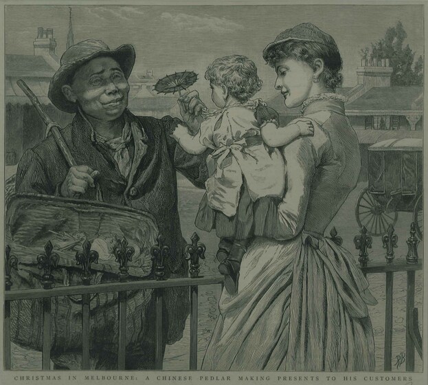 A man and a woman stand on either side of a wrought iron fence - the woman is holding a small child and leaning slightly over so the child can reach the man, they are both dressed in Victorian era clothing. The man is wearing an overcoat, hat and carrying a large carpet bag. He is holding out a small gift shaped like a flower to the child.