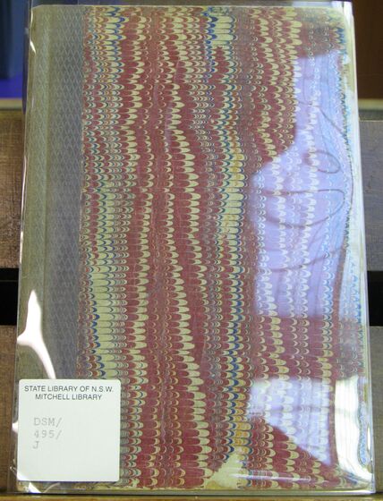 Front cover of a book with plastic covering that is reflecting into the camera.