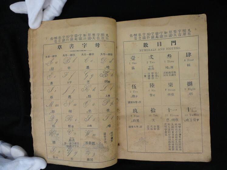 Double page book with Cantonese characters and English translations.