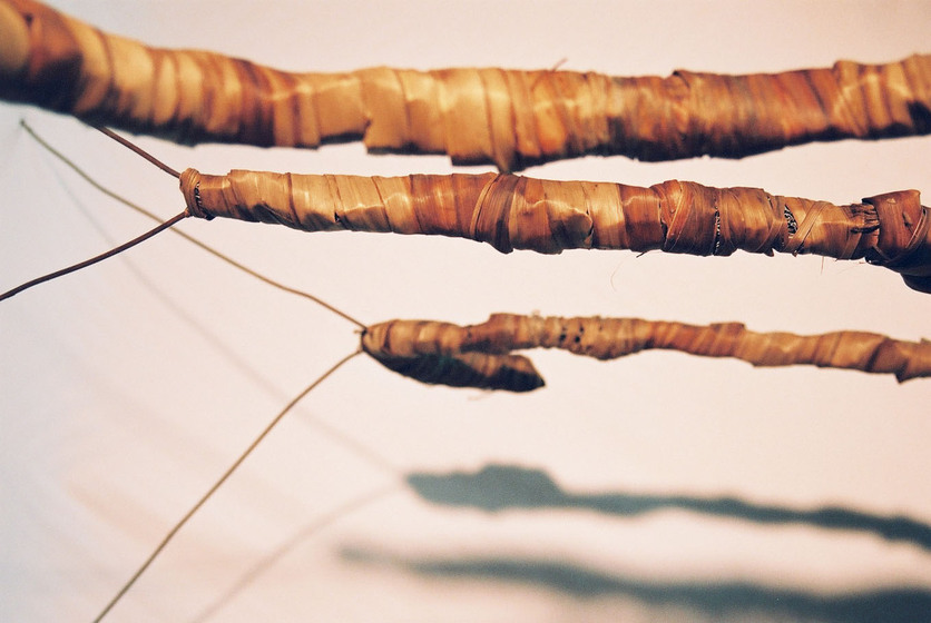 Curved wire wrapped in a type of rattan, reflecting the look of a tree branch.