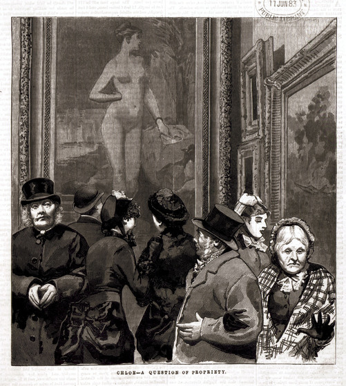 A group of men and women dressed in suits and formal dresses standing in front of a painting of a naked woman. Some people are staring at the painting while others are looking front on with looks of disgust or contemplation on their faces.