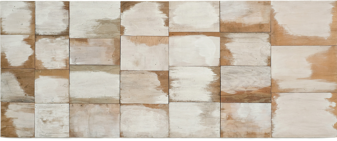 Panel made of rectangular pieces of wood partially painted white.